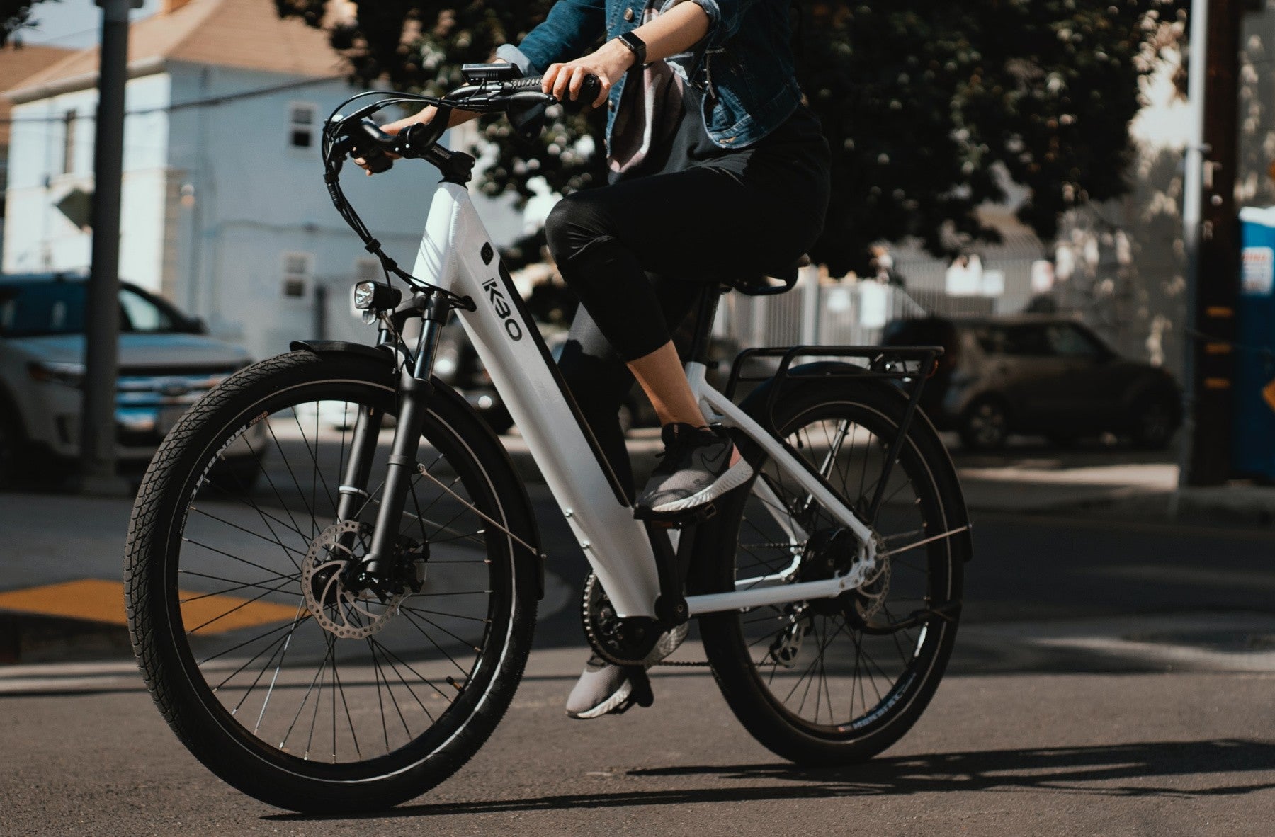 E-Ride Shop Home Page Image of a Person Riding a White Electric Bike