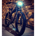 raven-ebike-in-colour-black-front-side-view-in-dark-with-lights-on